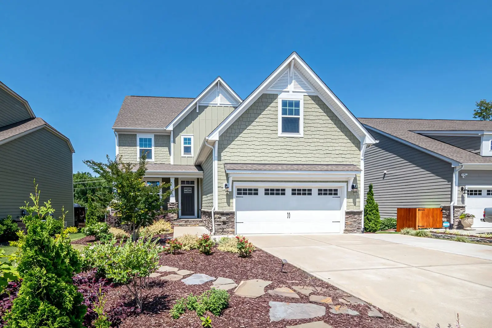 Craftsman-style home with a white double garage door