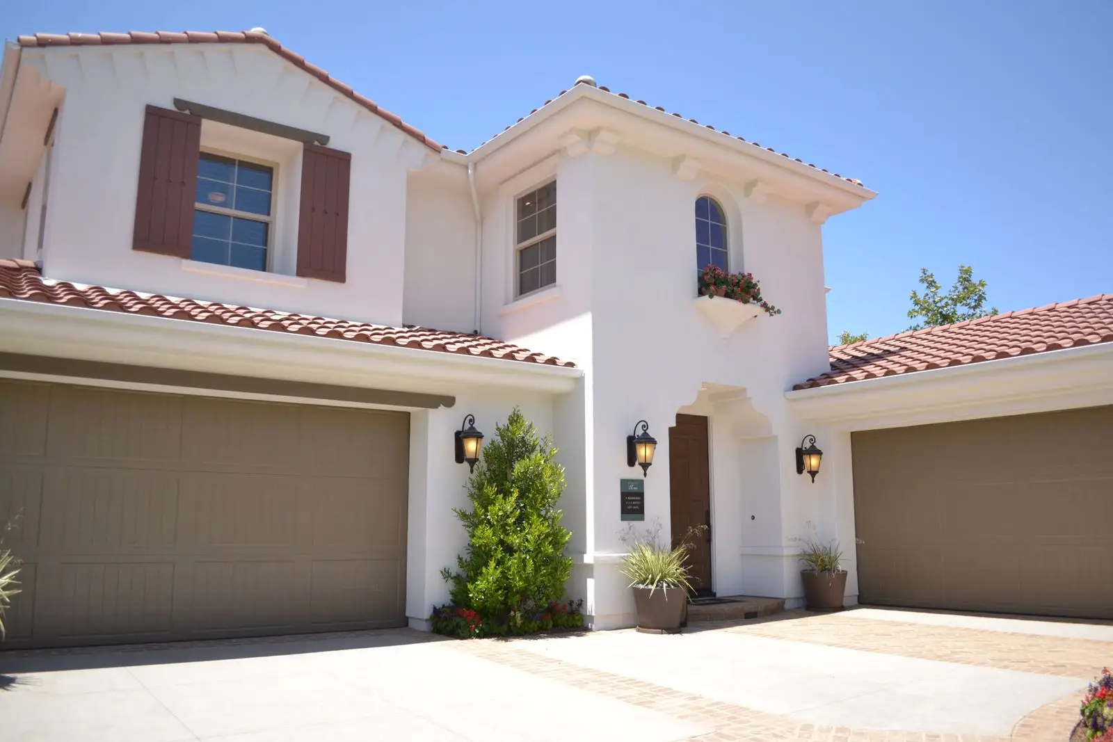 Spanish-style home with two garage doors